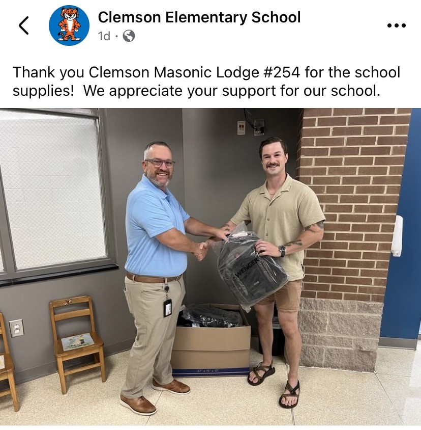 Brother Madison Rubin shakes hands with Clemson Elementary Principal David Thompson